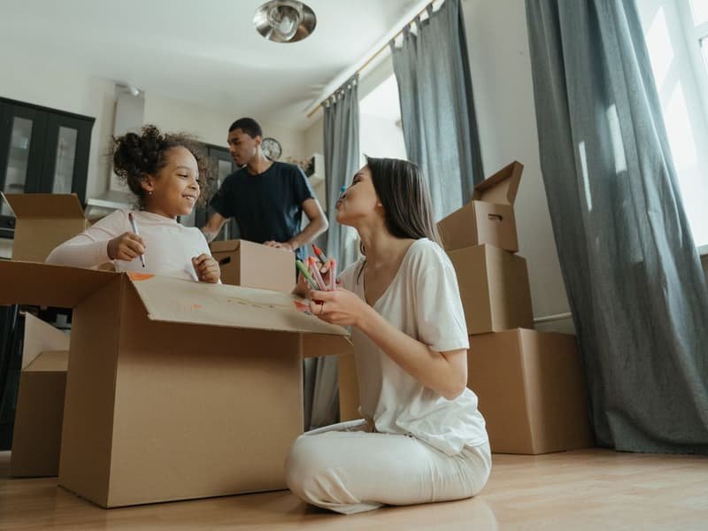 Family unpacking boxes in their new home