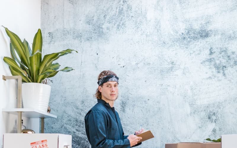 Mover checking inventory boxes in a warehouse